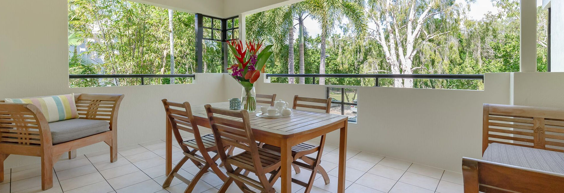 Private Balcony & Tropical Views Expansive private apartment balcony with outdoor seating and tropical views in Port Douglas